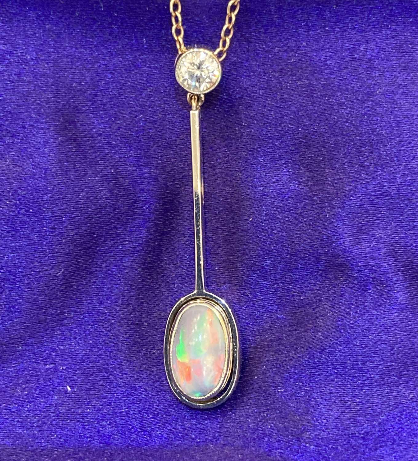 A black opal pendant with diamond baille